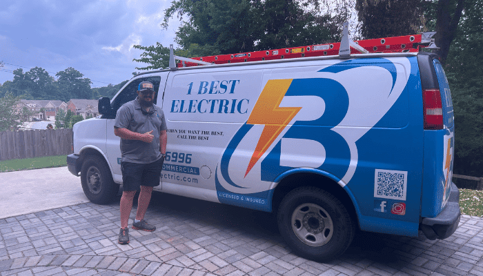 1 Best Electric technician standing beside a branded service van in Georgia.