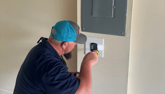 Licensed electrician installing a whole-home surge protector in Cartersville, GA.
